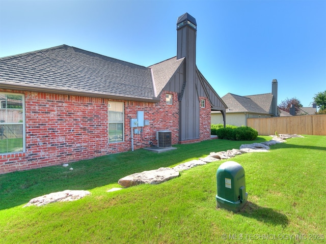 9314 S 76th E Ave, Tulsa, OK 74133 - rear view of property featuring brick siding, a chimney, and roof with shingles