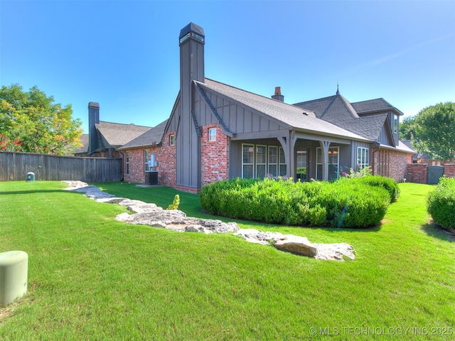 9314 S 76th E Ave, Tulsa, OK 74133 - view of property exterior featuring brick siding, a chimney, board and batten siding, and roof with shingles
