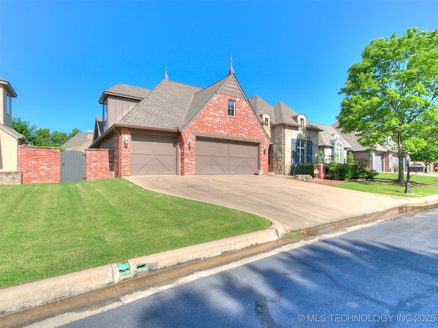 9314 S 76th E Ave, Tulsa, OK 74133 - view of front facade with brick siding, a front yard, concrete driveway, and roof with shingles