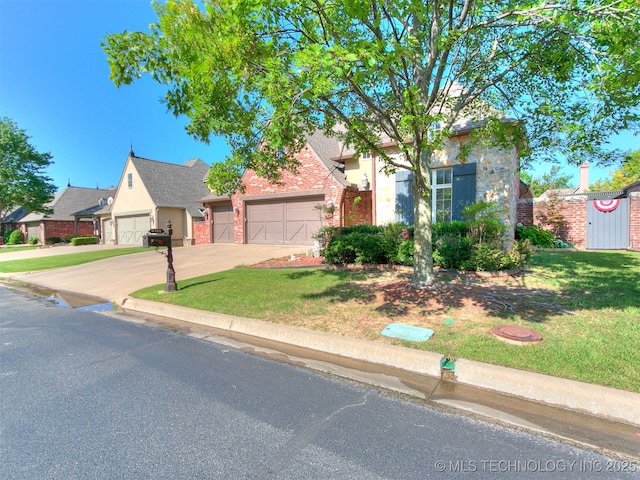 9314 S 76th E Ave, Tulsa, OK 74133 - obstructed view of property featuring driveway, a garage, brick siding, and a front lawn