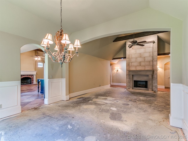 9314 S 76th E Ave, Tulsa, OK 74133 - unfurnished living room featuring a brick fireplace, a ceiling fan, lofted ceiling, arched walkways, and wainscoting