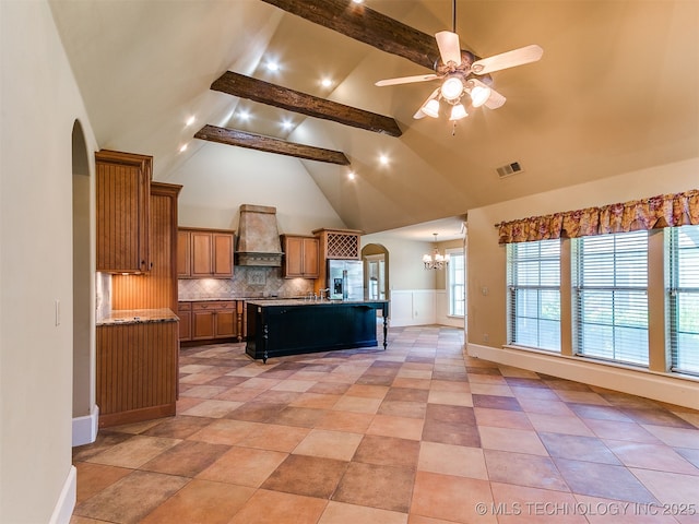 9314 S 76th E Ave, Tulsa, OK 74133 - kitchen featuring arched walkways, stainless steel fridge, a chandelier, premium range hood, and high vaulted ceiling
