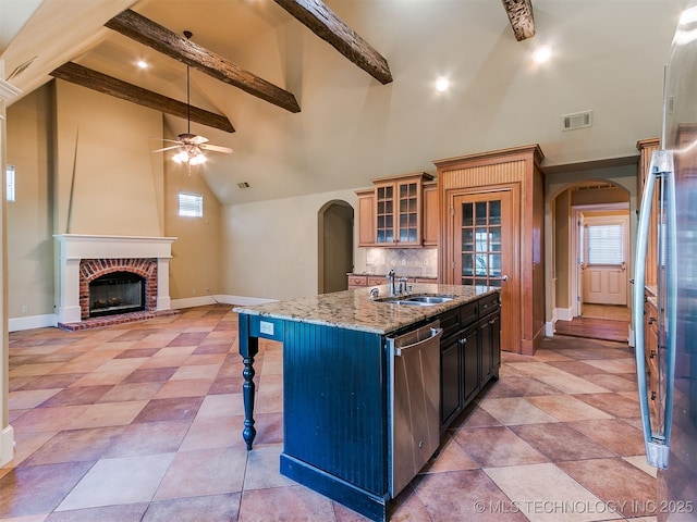 9314 S 76th E Ave, Tulsa, OK 74133 - kitchen with arched walkways, appliances with stainless steel finishes, ceiling fan, a kitchen breakfast bar, and beam ceiling
