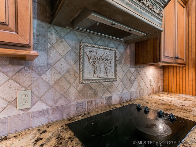 9314 S 76th E Ave, Tulsa, OK 74133 - kitchen with black electric cooktop, ventilation hood, and brown cabinetry