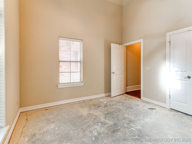 9314 S 76th E Ave, Tulsa, OK 74133 - unfurnished bedroom with a towering ceiling and baseboards