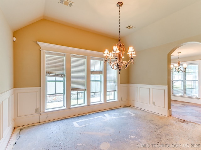 9314 S 76th E Ave, Tulsa, OK 74133 - unfurnished dining area featuring a chandelier, wainscoting, vaulted ceiling, arched walkways, and a decorative wall