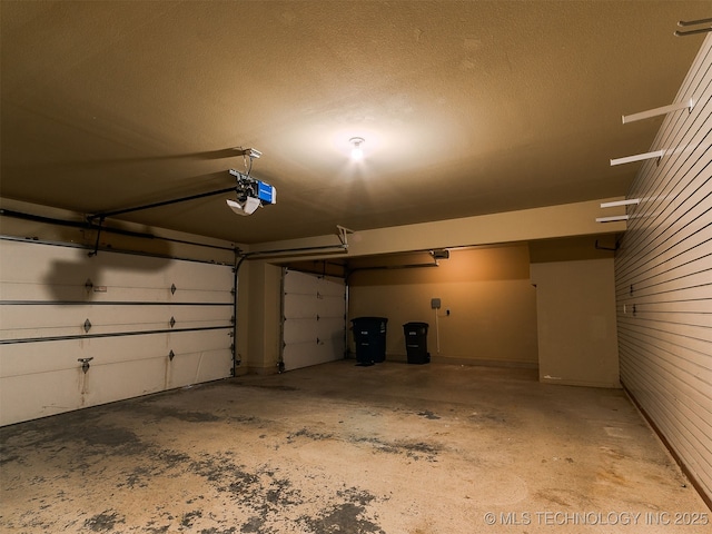 9314 S 76th E Ave, Tulsa, OK 74133 - garage featuring a garage door opener and wooden walls