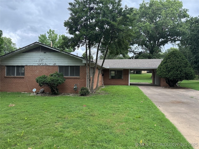 2306 Hill Dr, Bartlesville, OK 74006 - single story home featuring a carport, brick siding, concrete driveway, and a front lawn