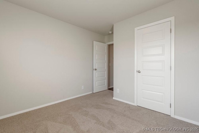 14203 N 76th Ave, Collinsville, OK 74021 - unfurnished bedroom with carpet and baseboards
