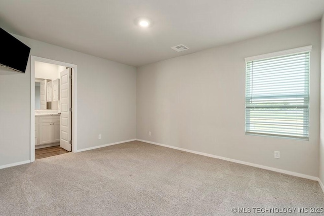 14203 N 76th Ave, Collinsville, OK 74021 - unfurnished bedroom featuring carpet flooring and connected bathroom