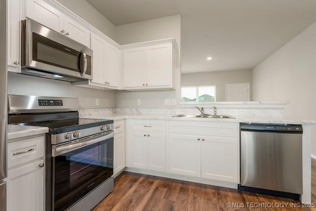 14203 N 76th Ave, Collinsville, OK 74021 - kitchen with stainless steel appliances, dark wood-style floors, white cabinets, light stone countertops, and recessed lighting