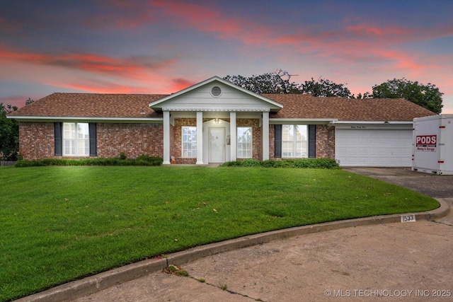 1533 Terrill Cir, Sapulpa, OK 74066 - greek revival house with driveway, an attached garage, a shingled roof, a front yard, and brick siding