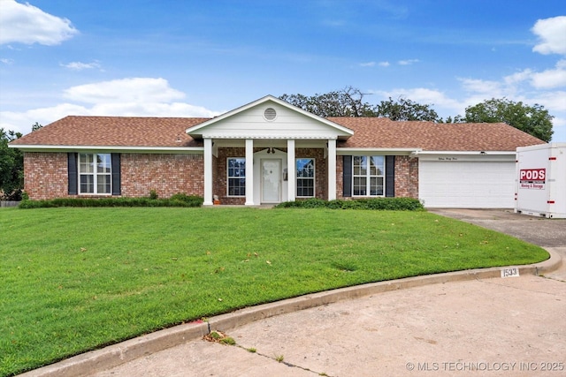 1533 Terrill Cir, Sapulpa, OK 74066 - view of front facade with a shingled roof, concrete driveway, a garage, a front yard, and brick siding