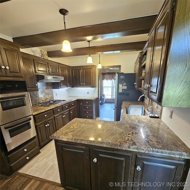 1533 Terrill Cir, Sapulpa, OK 74066 - kitchen featuring stainless steel appliances, dark brown cabinetry, beam ceiling, backsplash, and light wood-type flooring