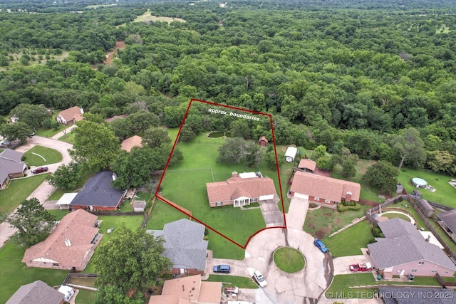 1533 Terrill Cir, Sapulpa, OK 74066 - aerial perspective of suburban area featuring a heavily wooded area and property parcel outlined