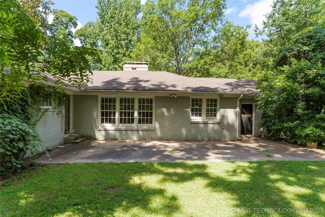 4135 S Zunis Ave, Tulsa, OK 74105 - back of property featuring brick siding, a lawn, a patio, and a shingled roof