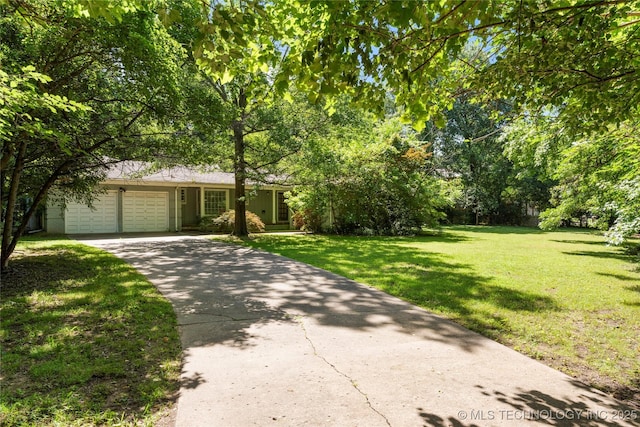 4135 S Zunis Ave, Tulsa, OK 74105 - view of front of home featuring an attached garage, concrete driveway, and a front yard