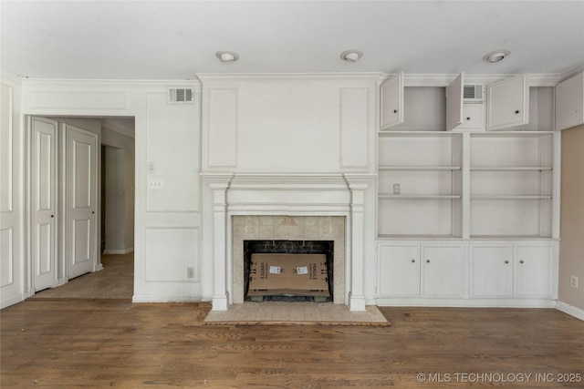 4135 S Zunis Ave, Tulsa, OK 74105 - unfurnished living room with wood finished floors, a fireplace, and crown molding