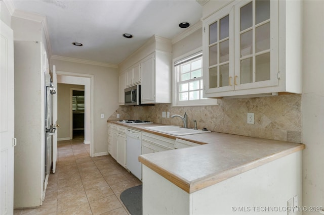 4135 S Zunis Ave, Tulsa, OK 74105 - kitchen with white appliances, a peninsula, decorative backsplash, glass insert cabinets, and light countertops