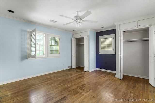 4135 S Zunis Ave, Tulsa, OK 74105 - unfurnished bedroom with two closets, crown molding, wood finished floors, and a ceiling fan