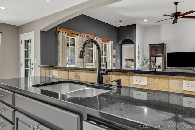 1116 W Fargo Dr, Broken Arrow, OK 74012 - kitchen with recessed lighting, ceiling fan, dark stone countertops, and white dishwasher