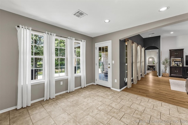 1116 W Fargo Dr, Broken Arrow, OK 74012 - spare room featuring arched walkways, recessed lighting, and light tile patterned floors
