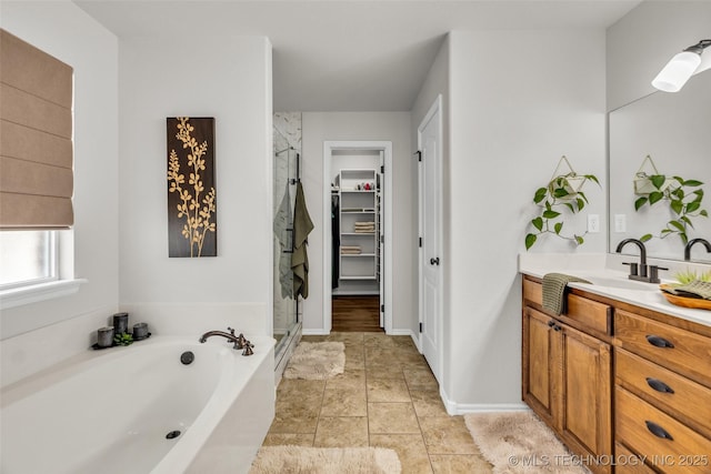 1116 W Fargo Dr, Broken Arrow, OK 74012 - bathroom with a shower stall, vanity, a garden tub, and a walk in closet