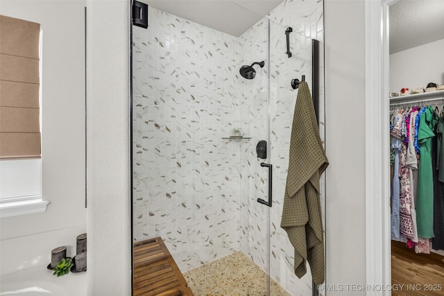 1116 W Fargo Dr, Broken Arrow, OK 74012 - bathroom featuring a shower stall, a spacious closet, and wood finished floors
