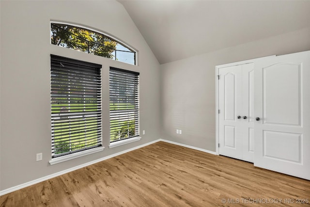 1116 W Fargo Dr, Broken Arrow, OK 74012 - unfurnished bedroom featuring wood finished floors, vaulted ceiling, and a closet