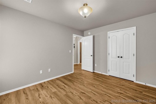 1116 W Fargo Dr, Broken Arrow, OK 74012 - unfurnished bedroom with wood finished floors and a closet