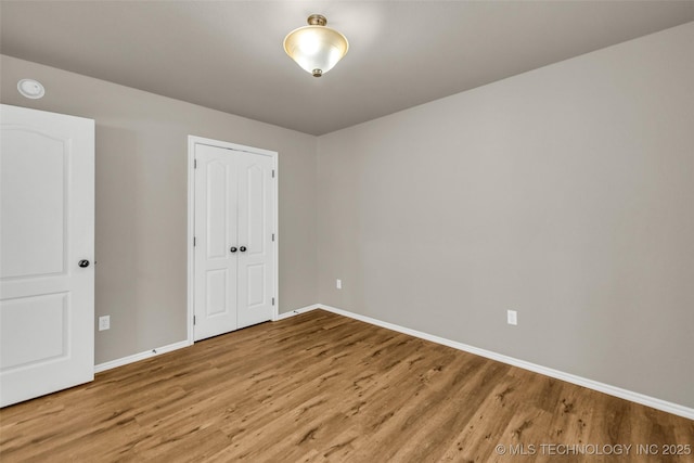 1116 W Fargo Dr, Broken Arrow, OK 74012 - unfurnished bedroom featuring wood finished floors and a closet