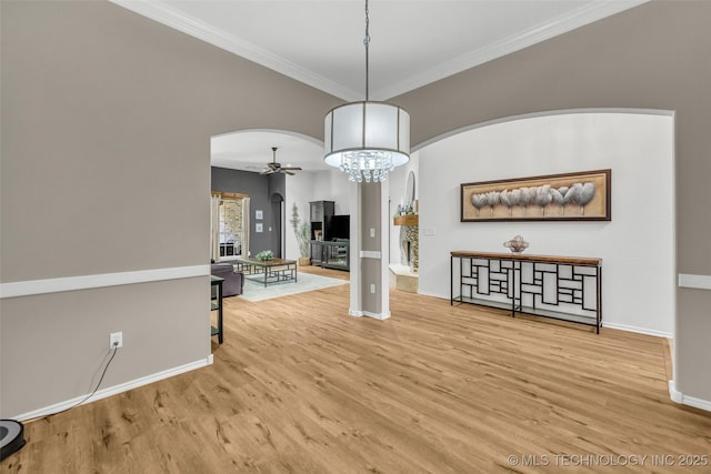 1116 W Fargo Dr, Broken Arrow, OK 74012 - unfurnished dining area with arched walkways, a ceiling fan, a chandelier, wood finished floors, and crown molding