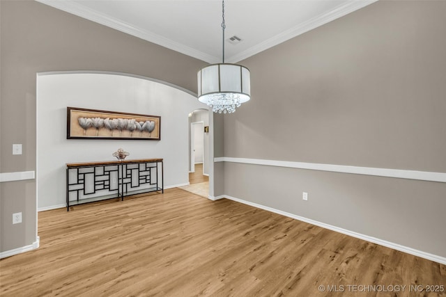 1116 W Fargo Dr, Broken Arrow, OK 74012 - unfurnished room with arched walkways, ornamental molding, wood finished floors, and a chandelier