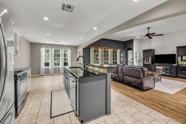 1116 W Fargo Dr, Broken Arrow, OK 74012 - kitchen featuring black range with gas cooktop, dark countertops, freestanding refrigerator, light tile patterned floors, and recessed lighting