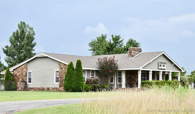 71279 S 270th Rd, Wagoner, OK 74467 - view of front of home featuring stone siding, a chimney, a front yard, and covered porch