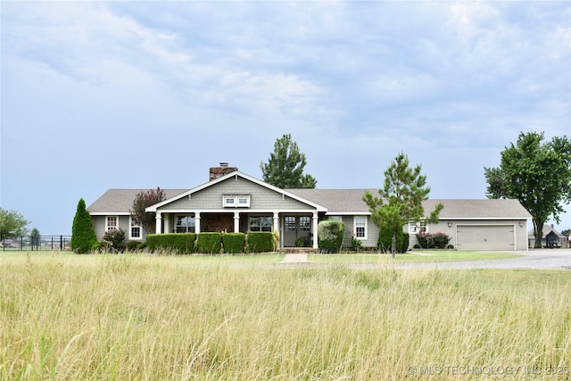 71279 S 270th Rd, Wagoner, OK 74467 - craftsman house featuring a chimney, a garage, and driveway