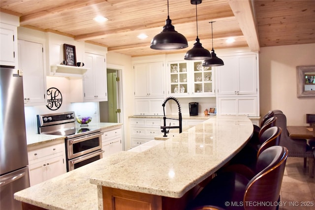 71279 S 270th Rd, Wagoner, OK 74467 - kitchen with appliances with stainless steel finishes, a wooden ceiling with exposed beams, a breakfast bar area, white cabinets, and recessed lighting