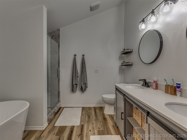 4004 S Sycamore Ave, Broken Arrow, OK 74011 - bathroom featuring wood finished floors, double vanity, a soaking tub, and a shower with door