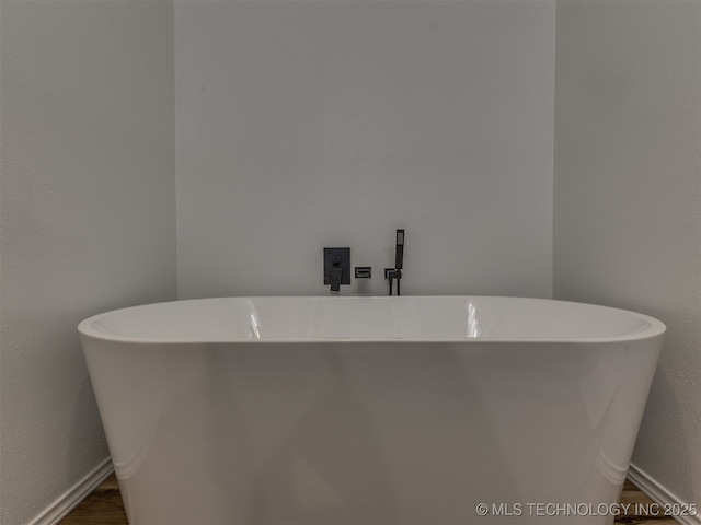 4004 S Sycamore Ave, Broken Arrow, OK 74011 - full bathroom featuring a soaking tub and a textured wall