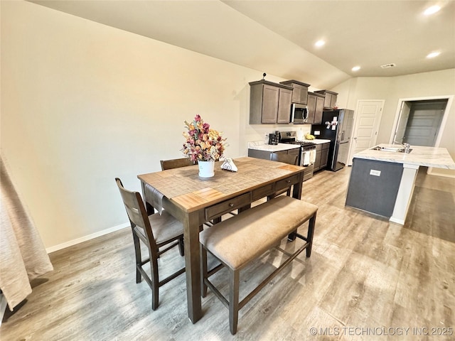 3907 S 150th E Ave, Tulsa, OK 74134 - dining area featuring light wood-style flooring, vaulted ceiling, and recessed lighting