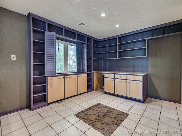 5704 E 65th St, Tulsa, OK 74136 - kitchen featuring open shelves, light brown cabinets, a textured ceiling, light tile patterned floors, and light countertops