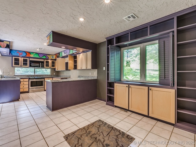 5704 E 65th St, Tulsa, OK 74136 - kitchen featuring open shelves, stainless steel range with electric stovetop, light tile patterned floors, black microwave, and a textured ceiling