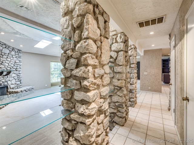 5704 E 65th St, Tulsa, OK 74136 - hall featuring tile patterned flooring, recessed lighting, a textured ceiling, and a skylight