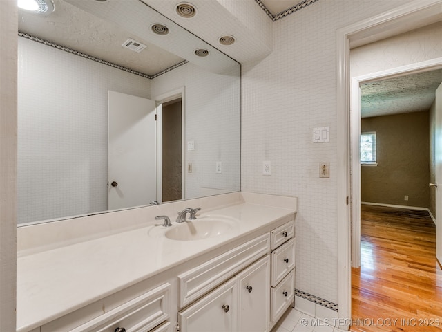 5704 E 65th St, Tulsa, OK 74136 - bathroom featuring vanity and wood finished floors