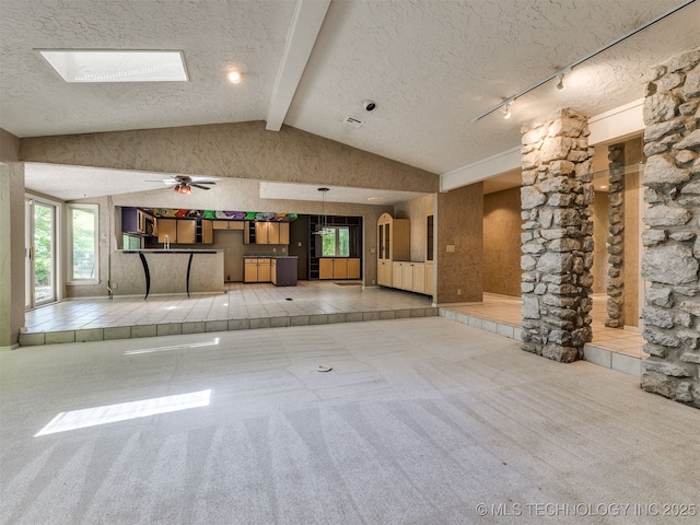 5704 E 65th St, Tulsa, OK 74136 - unfurnished living room with a textured ceiling, carpet flooring, and a ceiling fan