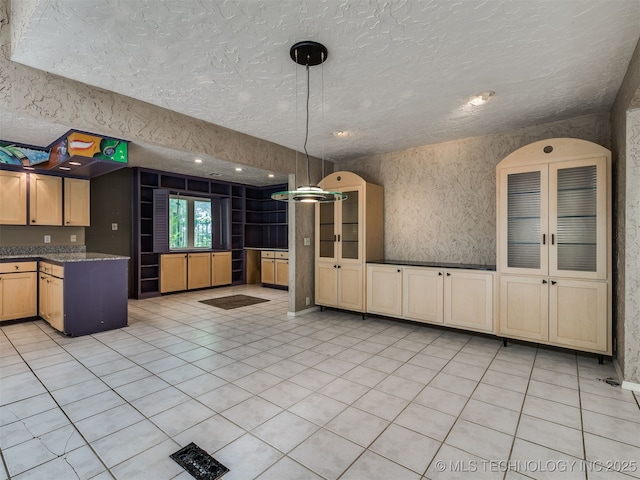 5704 E 65th St, Tulsa, OK 74136 - kitchen featuring a textured ceiling, hanging light fixtures, and light tile patterned floors