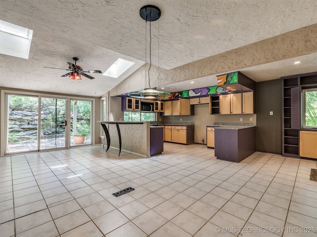 5704 E 65th St, Tulsa, OK 74136 - kitchen with a skylight, a peninsula, light tile patterned floors, high vaulted ceiling, and a textured ceiling
