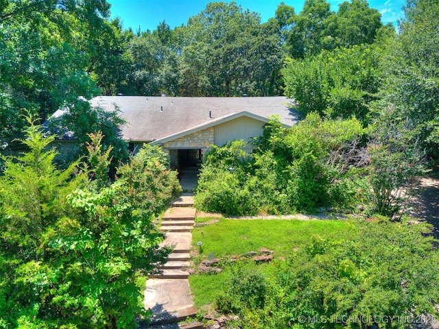 5704 E 65th St, Tulsa, OK 74136 - obstructed view of property with stone siding and roof with shingles