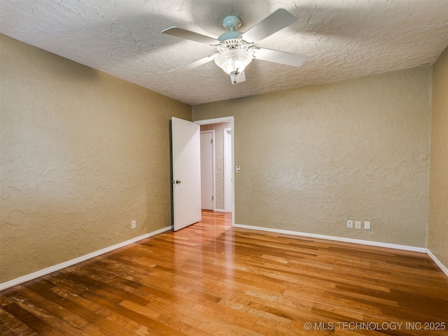 5704 E 65th St, Tulsa, OK 74136 - unfurnished room with a textured wall, wood finished floors, a ceiling fan, and a textured ceiling
