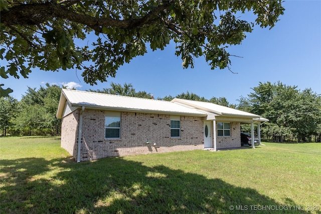 1404 Compelube Rd, Mcalester, OK 74501 - back of house featuring a lawn, a metal roof, and brick siding
